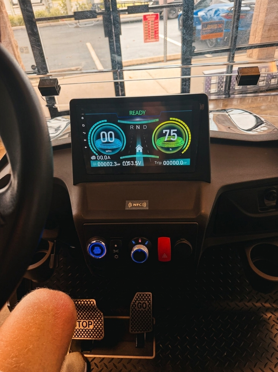 Electric golf cart touchscreen dashboard showing a READY display, digital gauges and controls